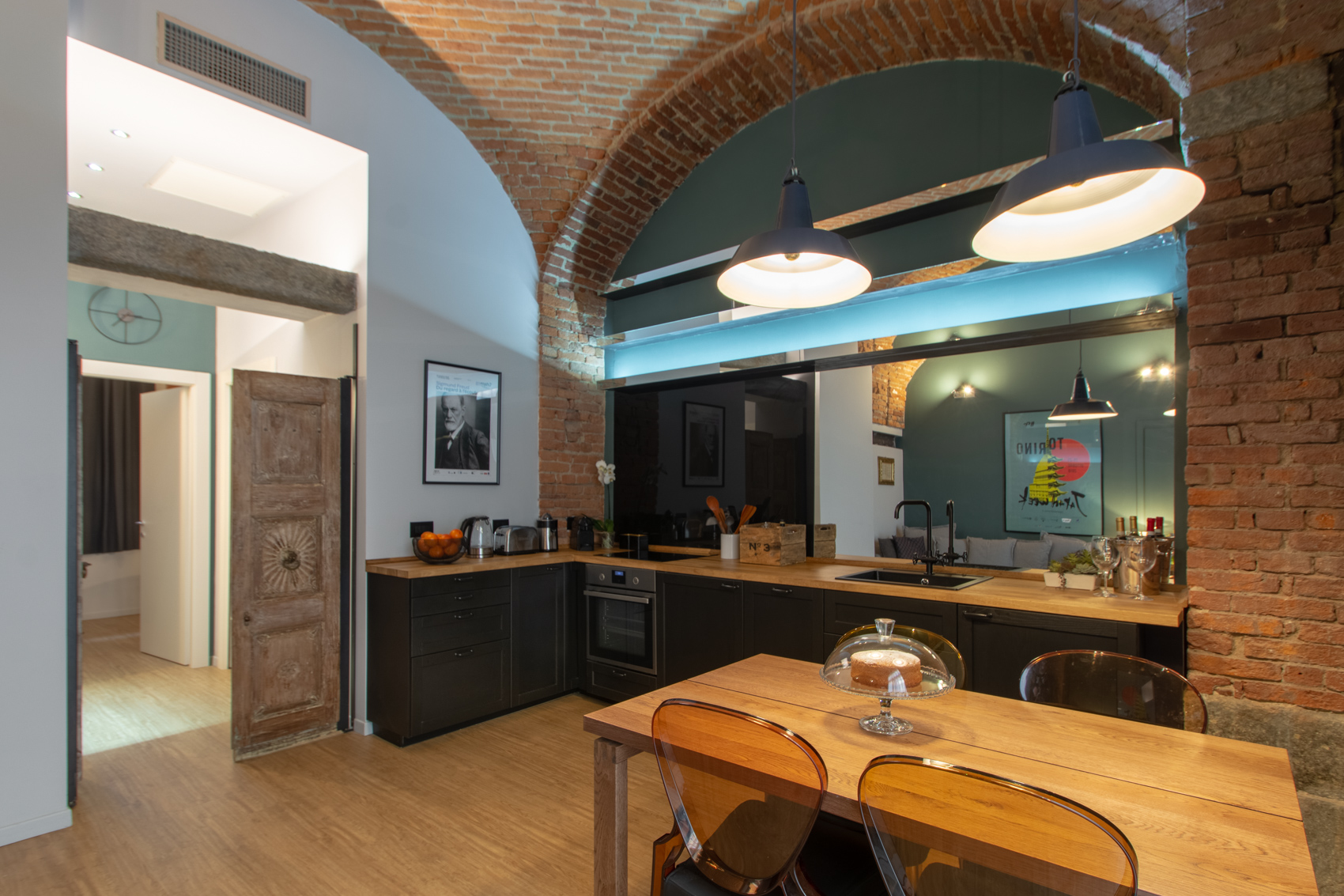 Kitchen and dining under the brick vaulted ceiling