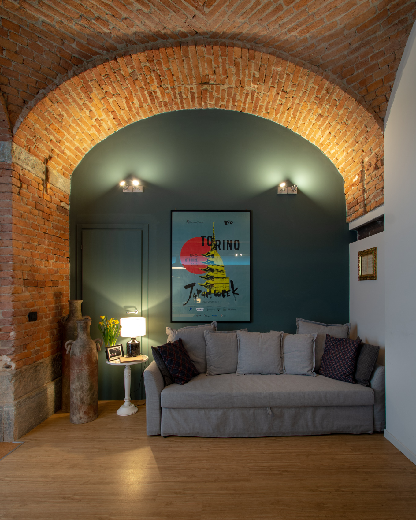 Living room with sofa bed under an exposed brick vaulted ceiling